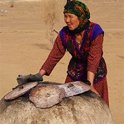 Karakum Desert - baking churek Turkmen bread in a tandyr clay oven